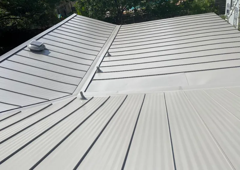 Solar attic fan installed on a metal roof for Roof Ventilation in Bemidji